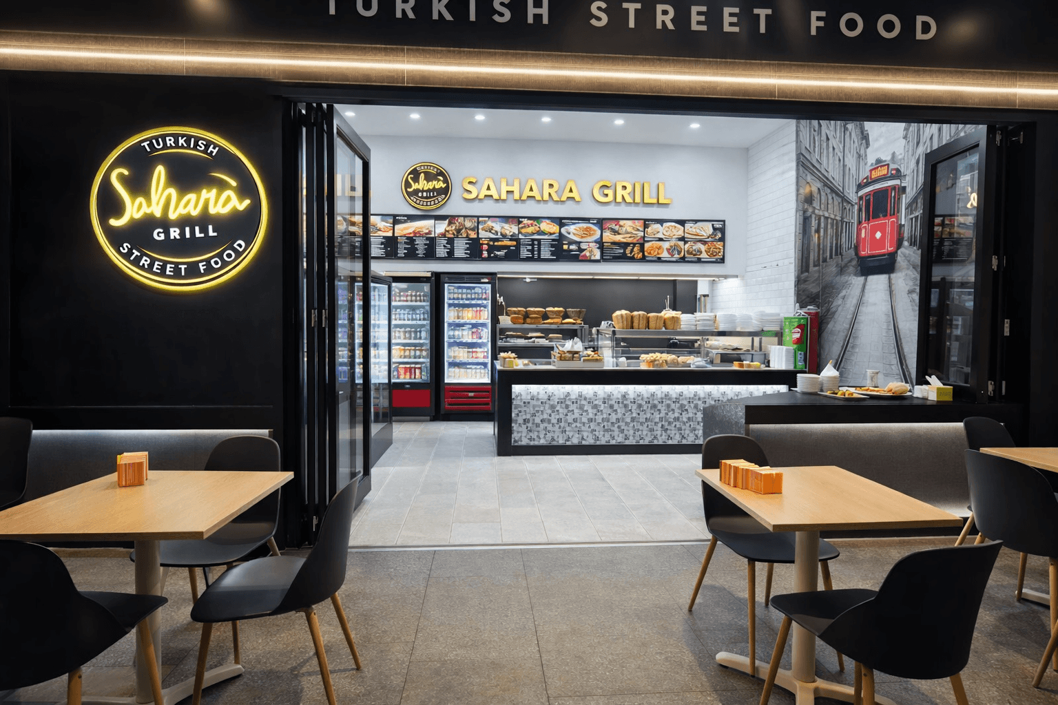 Sahara Grill's traditional Turkish flame-grilled kebabs being served in a premium black-and-gold dining setting in Campsie